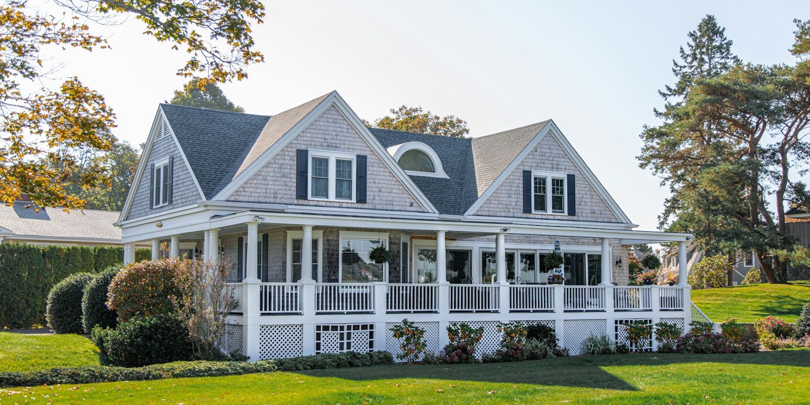 A gray wooden single-family house on a sunny day